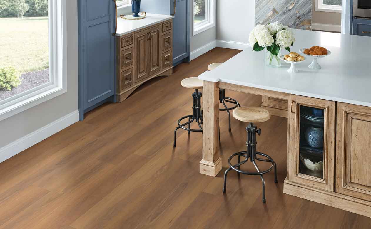 mid toned wood-look vinyl in modern kitchen with blue cabinets and kitchen island
