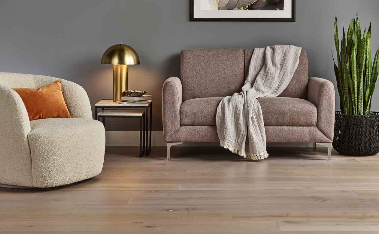 Herringbone patterned Hardwood Flooring in Living Room with Chair and Table