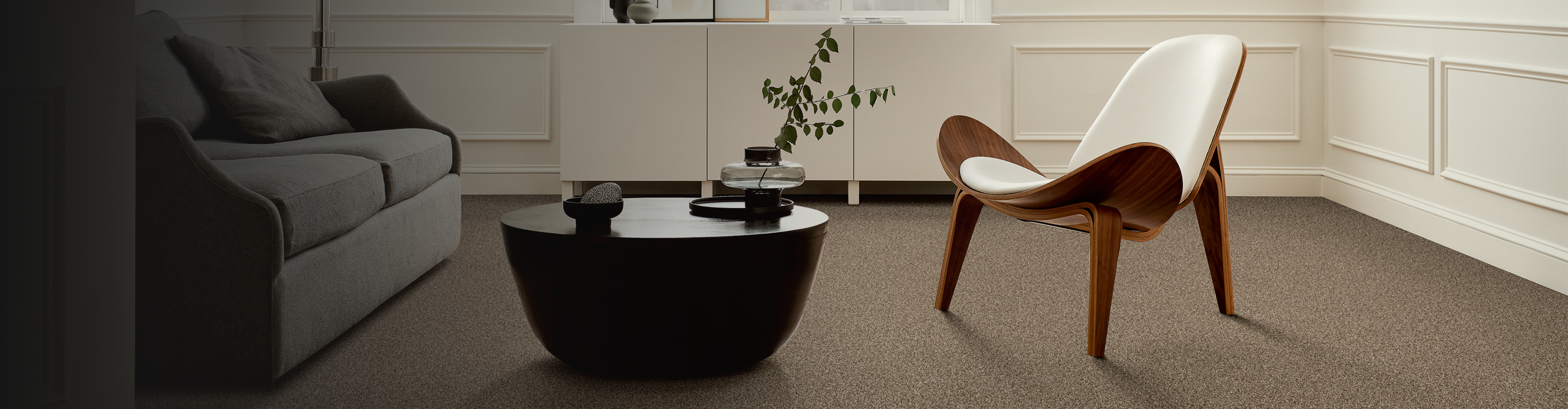 Beige carpet in a sitting area with a wood accent chair